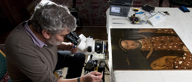 Dendrochronologist examines the wooden panels of Longleat's Henry VIII portrait banner. Pic: BNPS